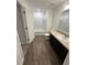 Bathroom with wood-look flooring, vanity, toilet, and a tub-shower combo at 366 Madison Dr, Davenport, FL 33837
