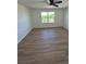 Bright bedroom with wood-look flooring, a ceiling fan, and a large window at 366 Madison Dr, Davenport, FL 33837