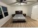 A bedroom featuring a dark wood bed set, ceiling fan, and natural lighting from a window at 366 Madison Dr, Davenport, FL 33837