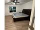 A bedroom featuring a dark wood bed set and natural lighting from a window at 366 Madison Dr, Davenport, FL 33837