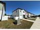 View of townhouse featuring neutral siding, a driveway, and a small front yard at 366 Madison Dr, Davenport, FL 33837