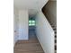 Bright foyer with wood-look flooring leading to the living areas and staircase at 366 Madison Dr, Davenport, FL 33837