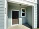 Close-up of the home's entrance featuring a dark door and exterior lighting at 366 Madison Dr, Davenport, FL 33837