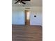 Hallway with consistent wood-look flooring connecting multiple rooms at 366 Madison Dr, Davenport, FL 33837