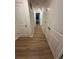 Hallway with multiple doors and wood-look flooring at 366 Madison Dr, Davenport, FL 33837
