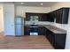 Modern kitchen with stainless steel appliances and dark cabinetry, ready for cooking at 366 Madison Dr, Davenport, FL 33837