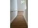 A staircase with wood steps and white walls, illuminated by natural light at 366 Madison Dr, Davenport, FL 33837