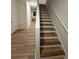 A staircase featuring wood steps, white risers, and a clean, modern design at 366 Madison Dr, Davenport, FL 33837