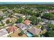 An aerial shot of a neighborhood highlighting homes with pools, lush greenery, and a nearby waterway at 4008 Lakeside Reserve Ct, Orlando, FL 32810