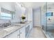 Modern bathroom with double sinks, granite countertops, and a glass-enclosed shower at 4008 Lakeside Reserve Ct, Orlando, FL 32810
