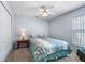 Cozy bedroom with neutral carpet, ceiling fan, and a comfortable bed with patterned comforter at 4008 Lakeside Reserve Ct, Orlando, FL 32810