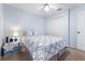 Bedroom featuring neutral carpet, ceiling fan, and a comfortable bed with a stylish patterned comforter at 4008 Lakeside Reserve Ct, Orlando, FL 32810