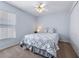Bright bedroom with a ceiling fan, neutral carpet, and a window with blinds at 4008 Lakeside Reserve Ct, Orlando, FL 32810