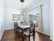 Elegant dining room featuring a glass-top table, stylish chairs, and a decorative chandelier at 4008 Lakeside Reserve Ct, Orlando, FL 32810