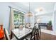 Bright dining area with modern table and chairs, open to the living area at 4008 Lakeside Reserve Ct, Orlando, FL 32810