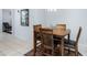 Cozy dining area featuring a wooden table and seating for four on a decorative rug at 4008 Lakeside Reserve Ct, Orlando, FL 32810