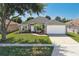 Charming single-story home with a well-manicured lawn and a two-car garage at 4008 Lakeside Reserve Ct, Orlando, FL 32810
