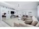 Bright living room with tile floors, a large sectional sofa, and access to the backyard at 4008 Lakeside Reserve Ct, Orlando, FL 32810