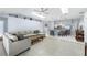 Open concept living space with tile floors, skylights, and a spacious seating area at 4008 Lakeside Reserve Ct, Orlando, FL 32810