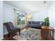 Cozy living room with hardwood floors, a comfortable sofa, and a patterned rug at 4008 Lakeside Reserve Ct, Orlando, FL 32810