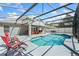 Enclosed pool area featuring a sparkling pool, lounge chairs, and outdoor dining set at 4008 Lakeside Reserve Ct, Orlando, FL 32810