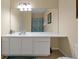 Well-lit bathroom with a full mirror over a large vanity, toilet, and neutral tile flooring at 4126 Breakview Dr # 40901, Orlando, FL 32819