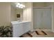 Bright bathroom features a white vanity with mirror, walk-in shower, and neutral tile flooring at 4126 Breakview Dr # 40901, Orlando, FL 32819