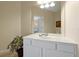 This bathroom is bright, offering a white vanity, a sink and a large mirror at 4126 Breakview Dr # 40901, Orlando, FL 32819