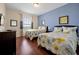 Bright guest bedroom with two beds, wood floors, a window, and lovely floral themed decor at 4126 Breakview Dr # 40901, Orlando, FL 32819