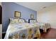 Bright guest bedroom with two beds, wood floors, and lovely floral themed bedding at 4126 Breakview Dr # 40901, Orlando, FL 32819