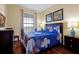 Cozy bedroom featuring queen-sized bed, two side tables, stylish lamps and vibrant wall art at 4126 Breakview Dr # 40901, Orlando, FL 32819