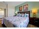 Inviting bedroom featuring queen size bed with a floral pattern, side tables and accent wall at 4126 Breakview Dr # 40901, Orlando, FL 32819