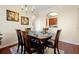 Formal dining room features wooden table, six chairs, chandelier, and decorative wall art at 4126 Breakview Dr # 40901, Orlando, FL 32819
