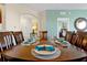 Spacious dining area with seating for six, with blue accent wall paint and decorative place settings at 4126 Breakview Dr # 40901, Orlando, FL 32819
