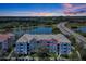 Condominium exterior showcasing multiple floors with balconies and sunset views, near a highway and lake at 4126 Breakview Dr # 40901, Orlando, FL 32819