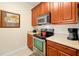 Modern kitchen with stainless steel appliances, wooden cabinets, and neutral countertops at 4126 Breakview Dr # 40901, Orlando, FL 32819