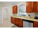 Well-lit kitchen with stainless steel appliances, light countertops and wooden cabinets at 4126 Breakview Dr # 40901, Orlando, FL 32819