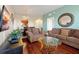 Comfortable living room with hardwood floors, complemented by a stylish glass coffee table and brown couches at 4126 Breakview Dr # 40901, Orlando, FL 32819