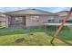 Home's backyard featuring a screened patio, trampoline, and swing set, perfect for Gathering fun and outdoor activities at 424 Lazio Cir, Debary, FL 32713