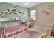 Charming bedroom with a custom bedframe, cozy chair, and whimsical decor, creating a comforting space at 424 Lazio Cir, Debary, FL 32713