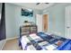 Well-lit bedroom with a calming blue color scheme featuring a TV and a unique custom quilt at 424 Lazio Cir, Debary, FL 32713
