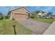 Inviting home featuring a paved driveway, a two-car garage, and lush green lawn at 424 Lazio Cir, Debary, FL 32713