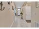 Inviting hallway with neutral paint and tile flooring and decorative wall fixtures at 424 Lazio Cir, Debary, FL 32713