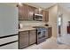 Modern kitchen with dark cabinets, stainless steel appliances, and granite countertops at 424 Lazio Cir, Debary, FL 32713