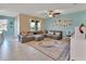 Comfortable living room with a large sectional sofa, stylish rug, and plenty of natural light at 424 Lazio Cir, Debary, FL 32713