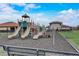 Community playground with slides and climbing structures with bench and safety guidelines at 424 Lazio Cir, Debary, FL 32713
