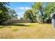 Expansive backyard featuring lush green grass and a wooden fence, perfect for outdoor relaxation at 4274 Tatum St, Orlando, FL 32811