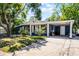 Charming single-story home with a covered carport, manicured lawn, and inviting curb appeal at 4274 Tatum St, Orlando, FL 32811
