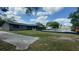 Backyard features a swimming pool, lush lawn, and mature trees, offering privacy at 434 Diamond Acres Rd, Davenport, FL 33837