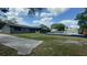 Backyard features a swimming pool, lush lawn, and mature trees, offering privacy at 434 Diamond Acres Rd, Davenport, FL 33837